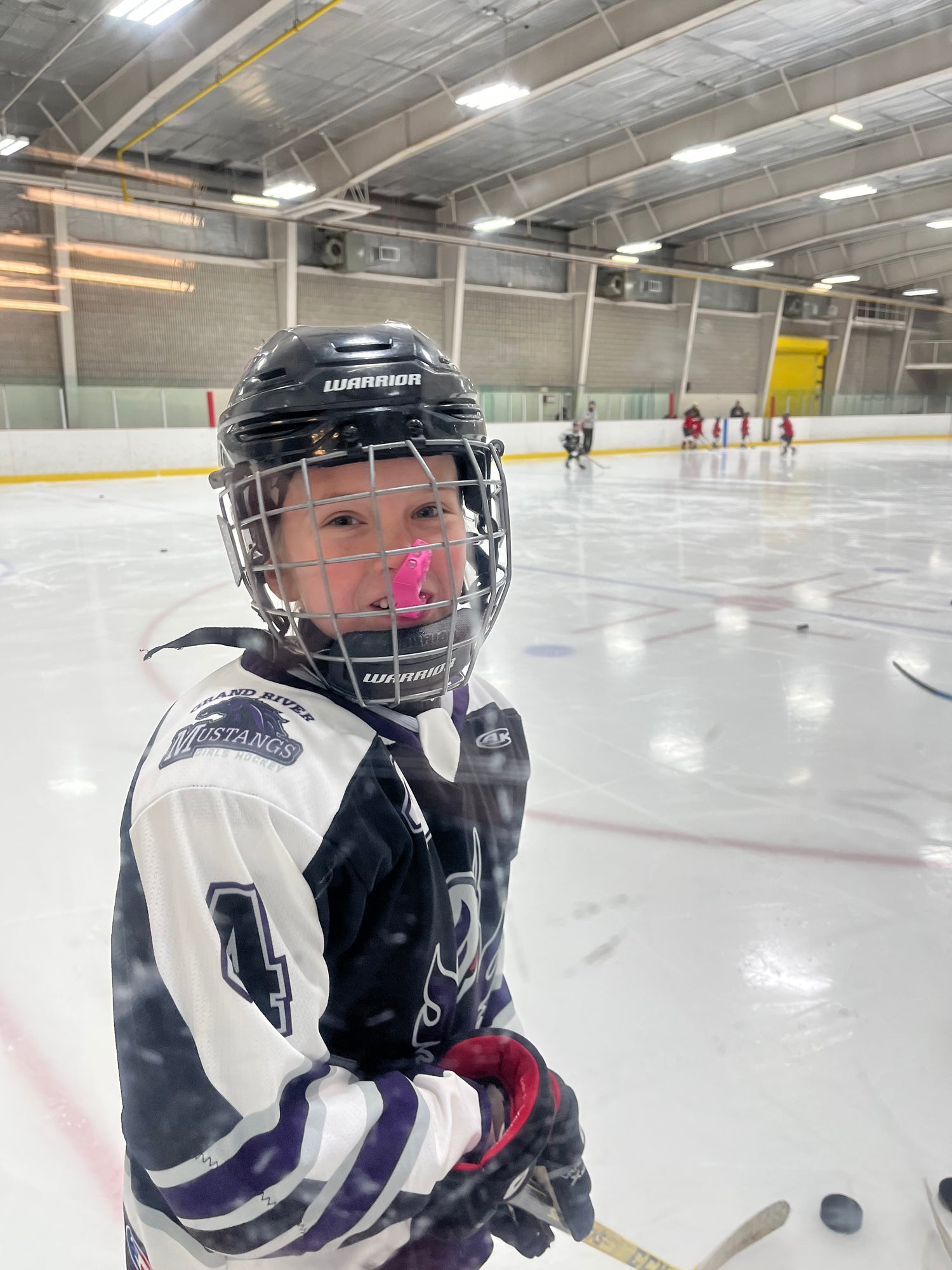 Libby on the ice, chewing a mouthgaurd